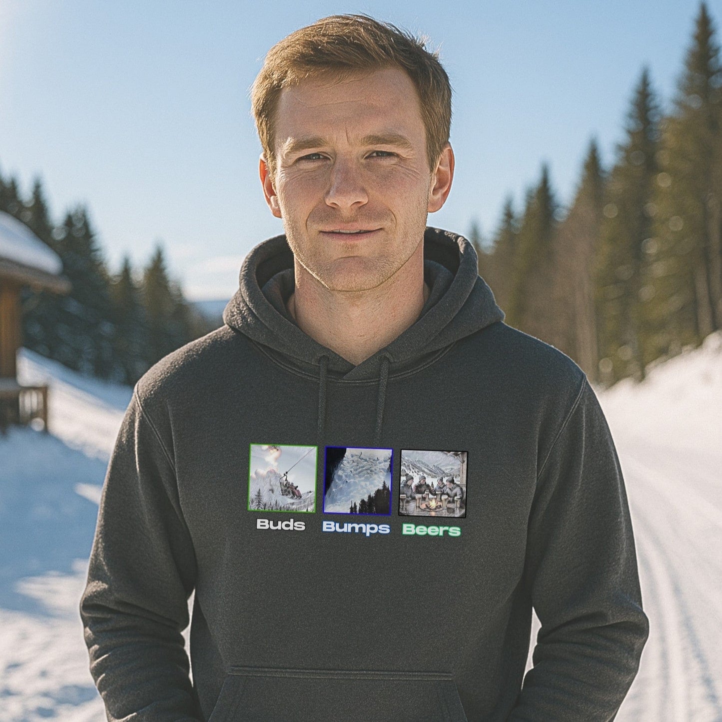 Charcoal hoodie with Buds Bumps Beers design, worn by a skier standing on a sunny snow-covered trail near the lodge.