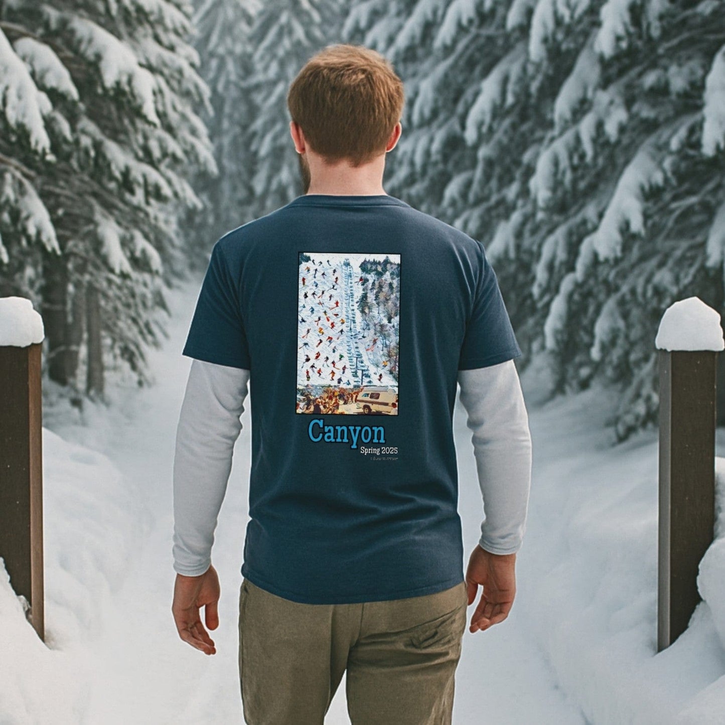 skier wearing navy canyon spring 2025 T-shirt with liftline crowd graphic walking through snow-covered trees