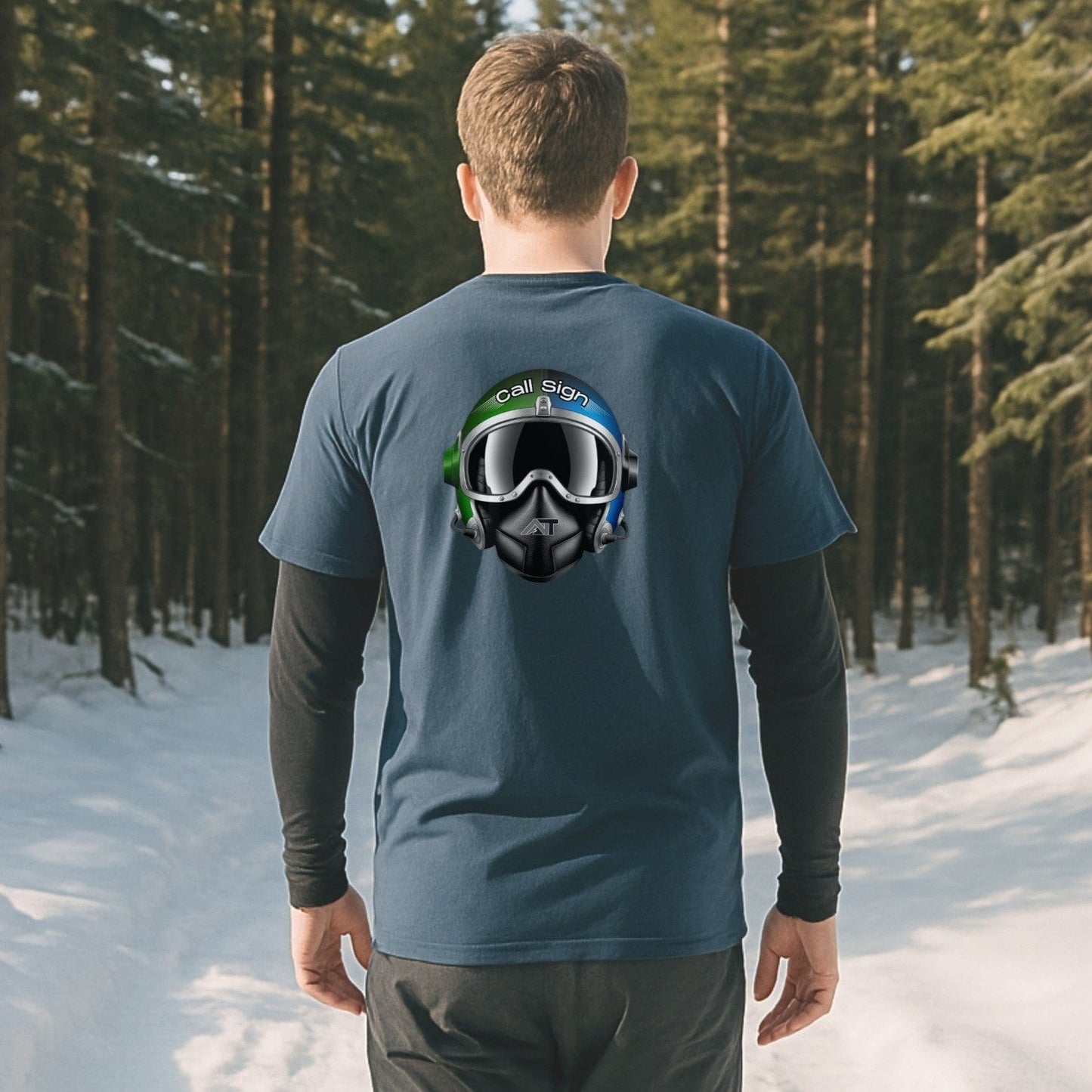 Indigo nice turns tee with call sign helmet graphic on back, worn on a snowy trail walk through pine trees on a bluebird day.