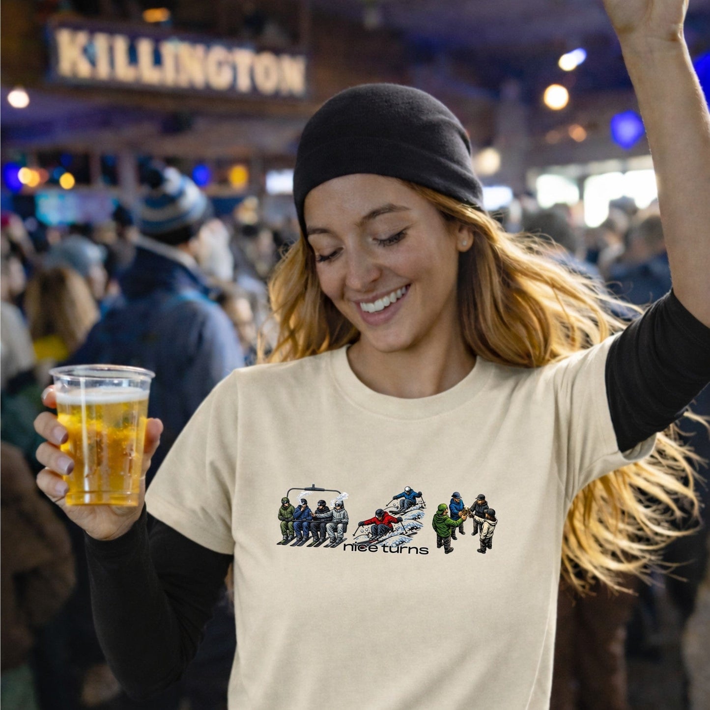 skier holding beer wearing buds bumps beers t-shirt natural front apres ski scene