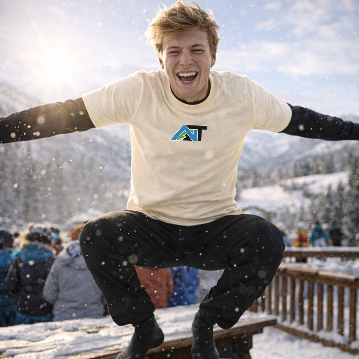 Male skier wearing natural t-shirt jumping outdoors in winter setting