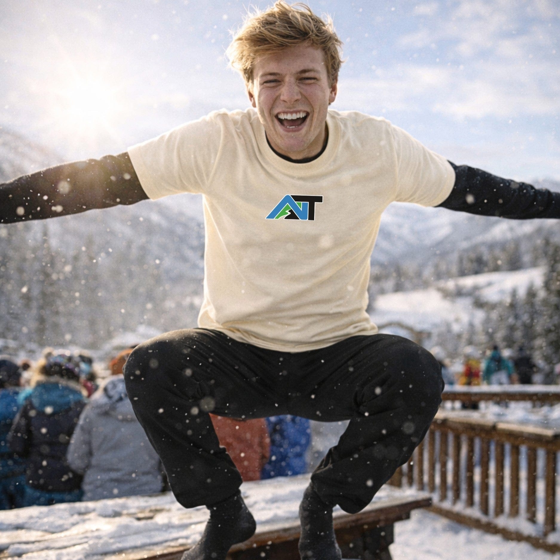 Male skier wearing natural t-shirt jumping outdoors in winter setting