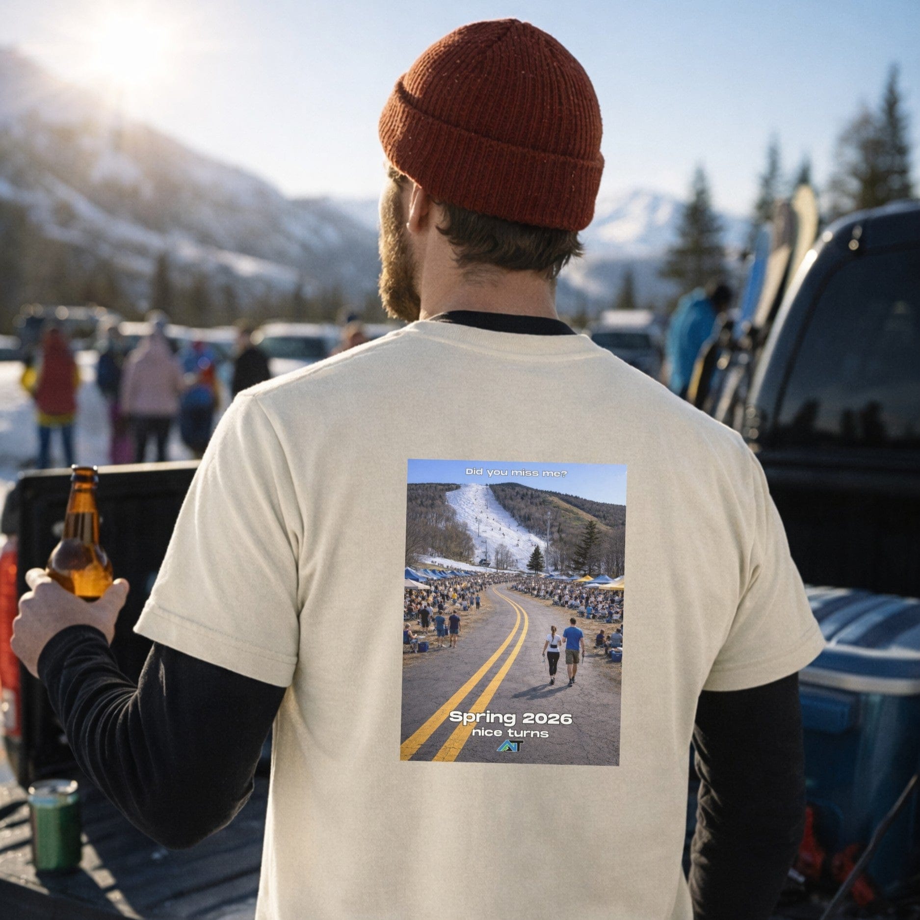Male skier wearing natural glacier t-shirt showing back graphic at tailgate