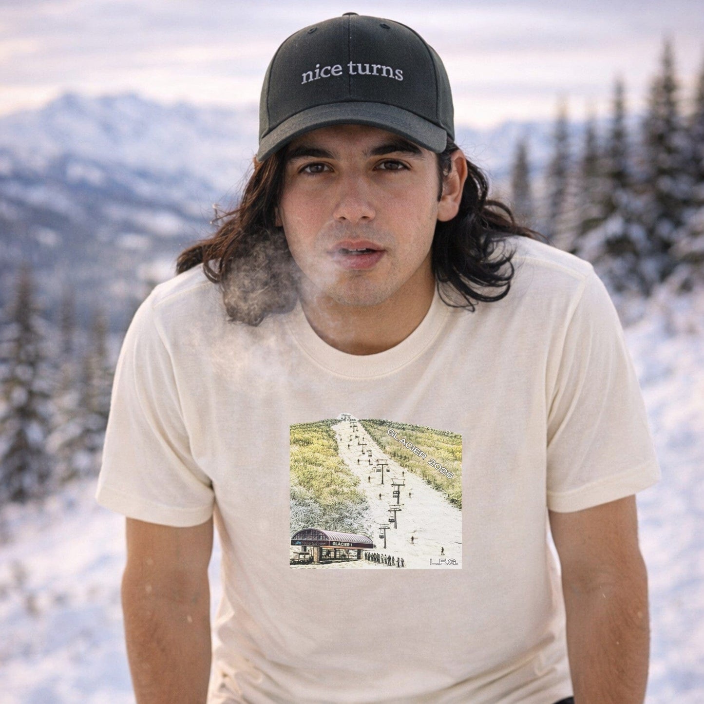 Male skier wearing natural glacier t-shirt front view in snowy mountain setting