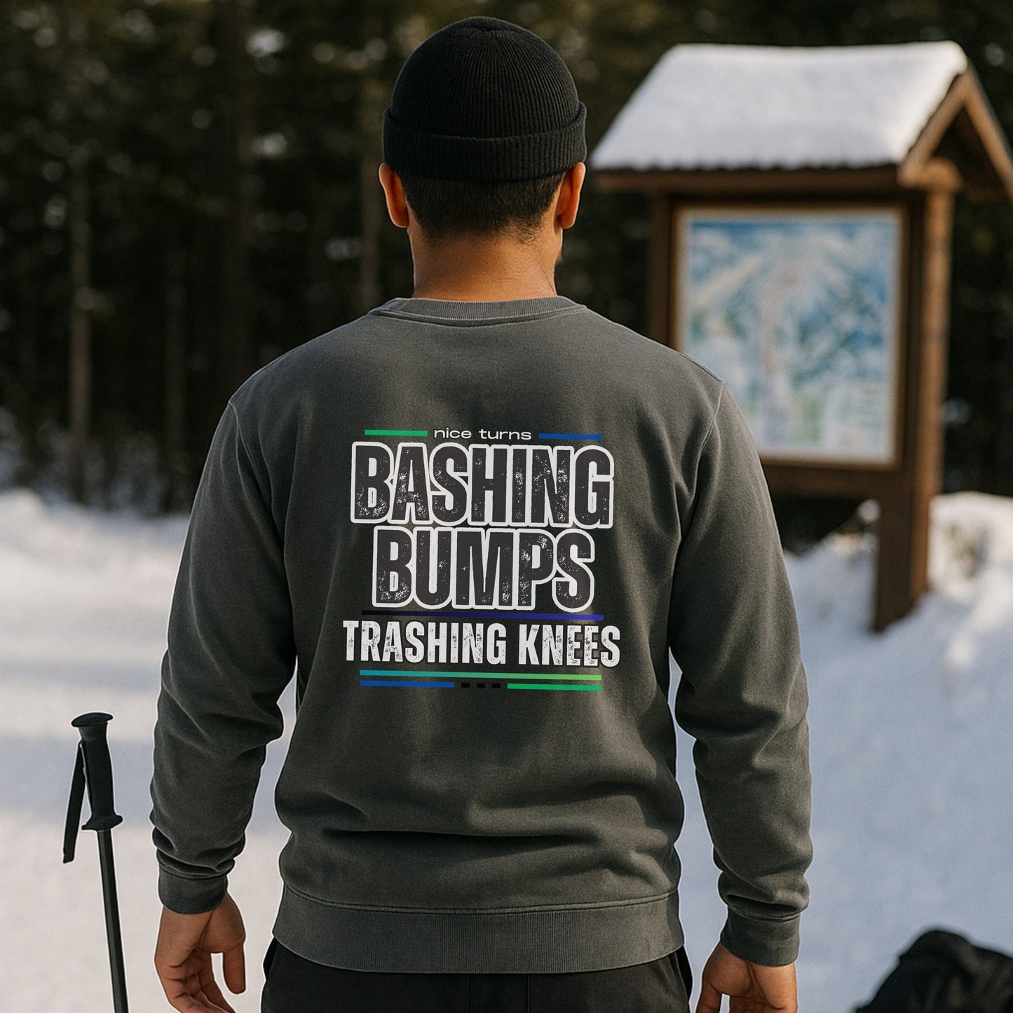 Bashing Bumps Sweatshirt, grey, back lifestyle view near trail map; “Bashing Bumps Trashing Knees” graphic centered; relaxed fit fleece.