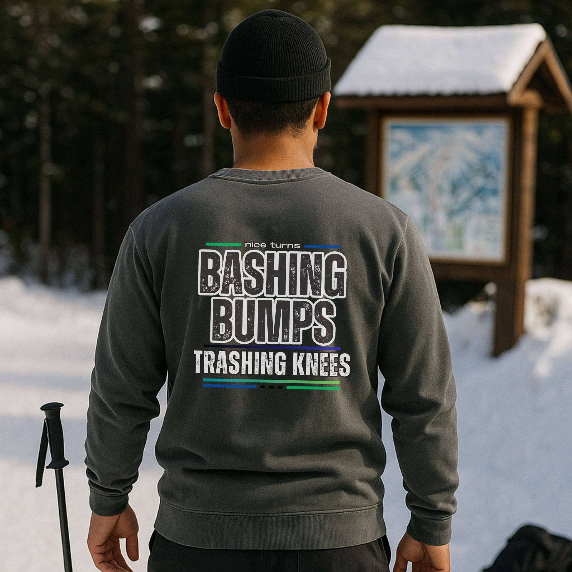 Bashing Bumps Sweatshirt, grey, back lifestyle view near trail map; “Bashing Bumps Trashing Knees” graphic centered; relaxed fit fleece.
