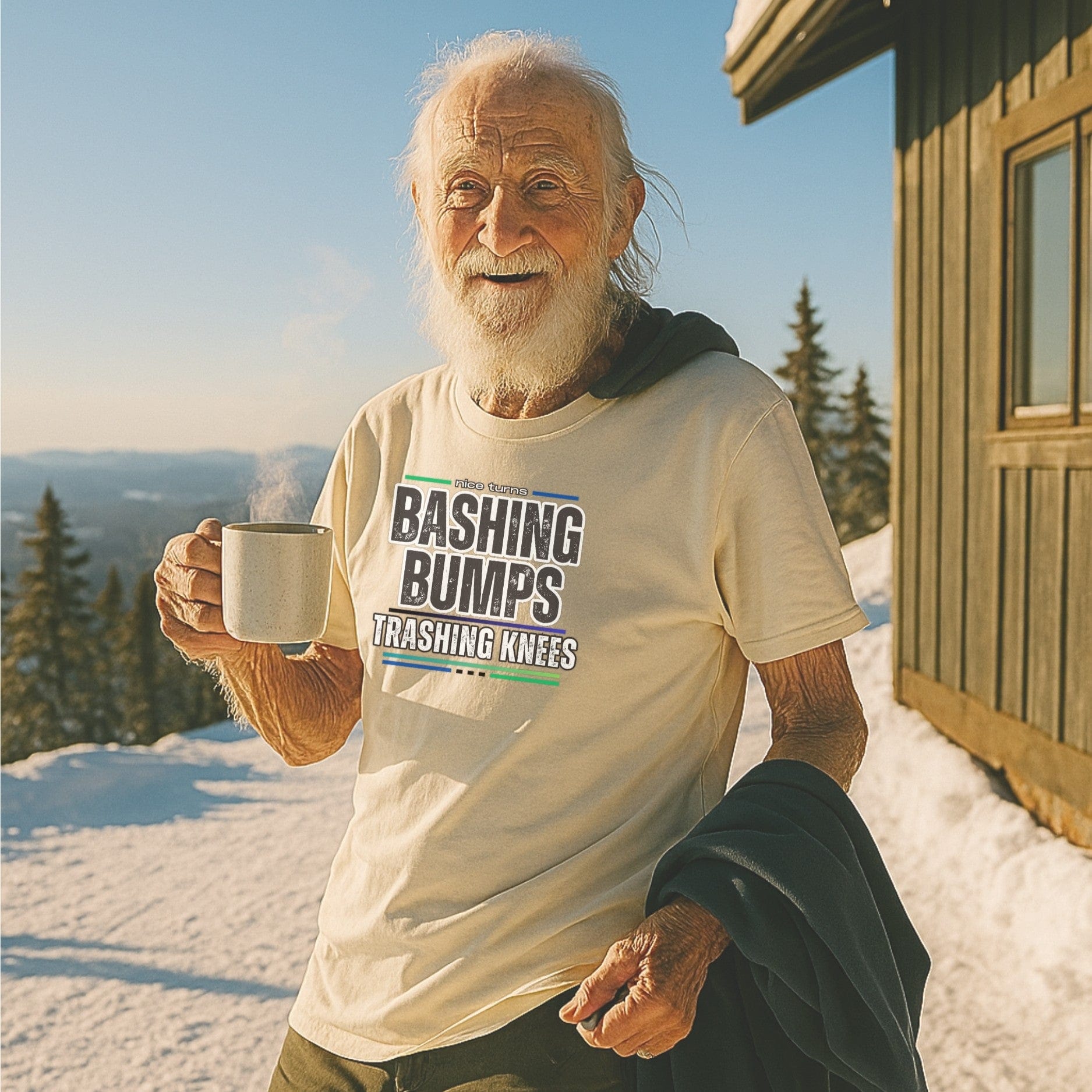 Elder skier in a “Bashing Bumps Trashing Knees” nice turns tee, sipping coffee on a sunlit summit deck with fresh snow and mountain views.
